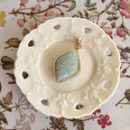 Texture detail of natural Amazonite cut into a petite rhombus, showcasing its soothing, matte sky-blue hue.