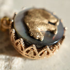 A macro shot detailing the shifting, rainbow-like nacre of the Black Mother-of-Pearl, which creates the magical, star-like quality of this constellation jewelry piece.