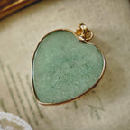 Texture detail of natural green aventurine stone showing its soothing jade hue and gold-plated bezel.