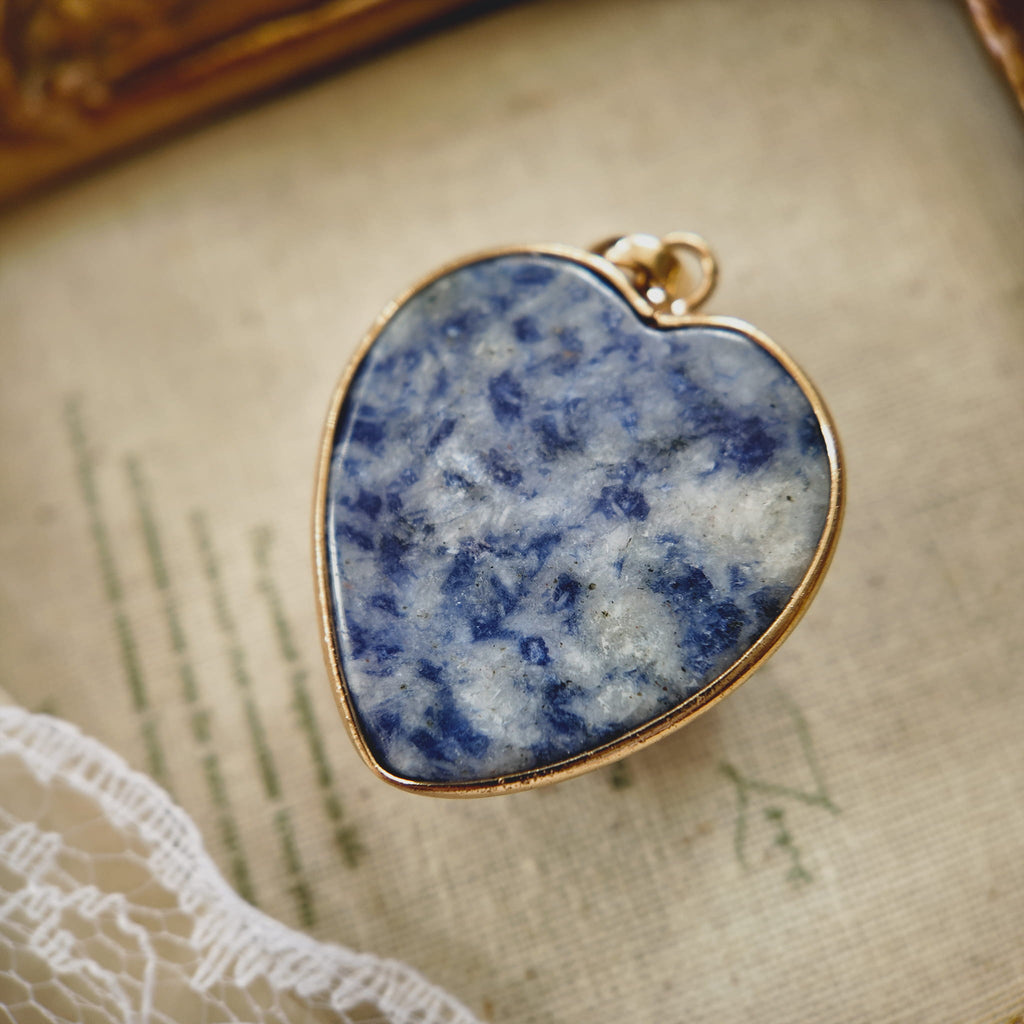 Texture detail of natural blue spot jade showing grey-blue mottled patterns resembling antique ceramic or granite.