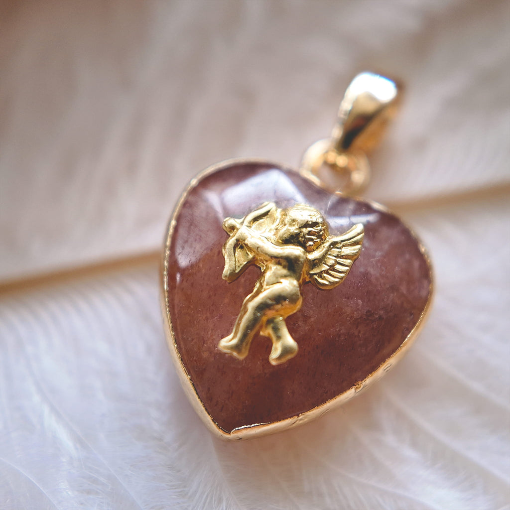 A macro shot detailing the visible internal red inclusions or "seeds" within the Natural Strawberry Quartz, which give the stone its characteristic "strawberry" look.