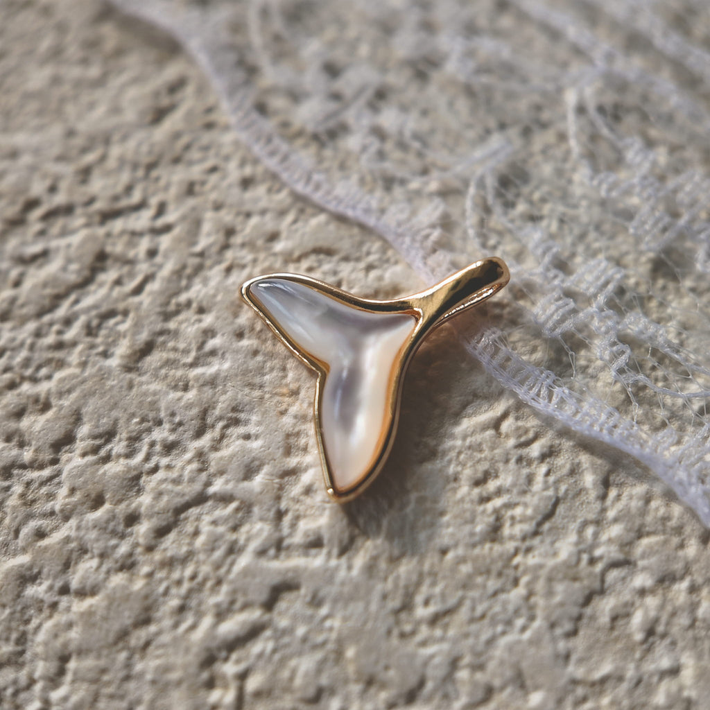 A macro shot detailing the natural, satin-like sheen and the subtle, iridescent colors within the Natural White Mother-of-Pearl.