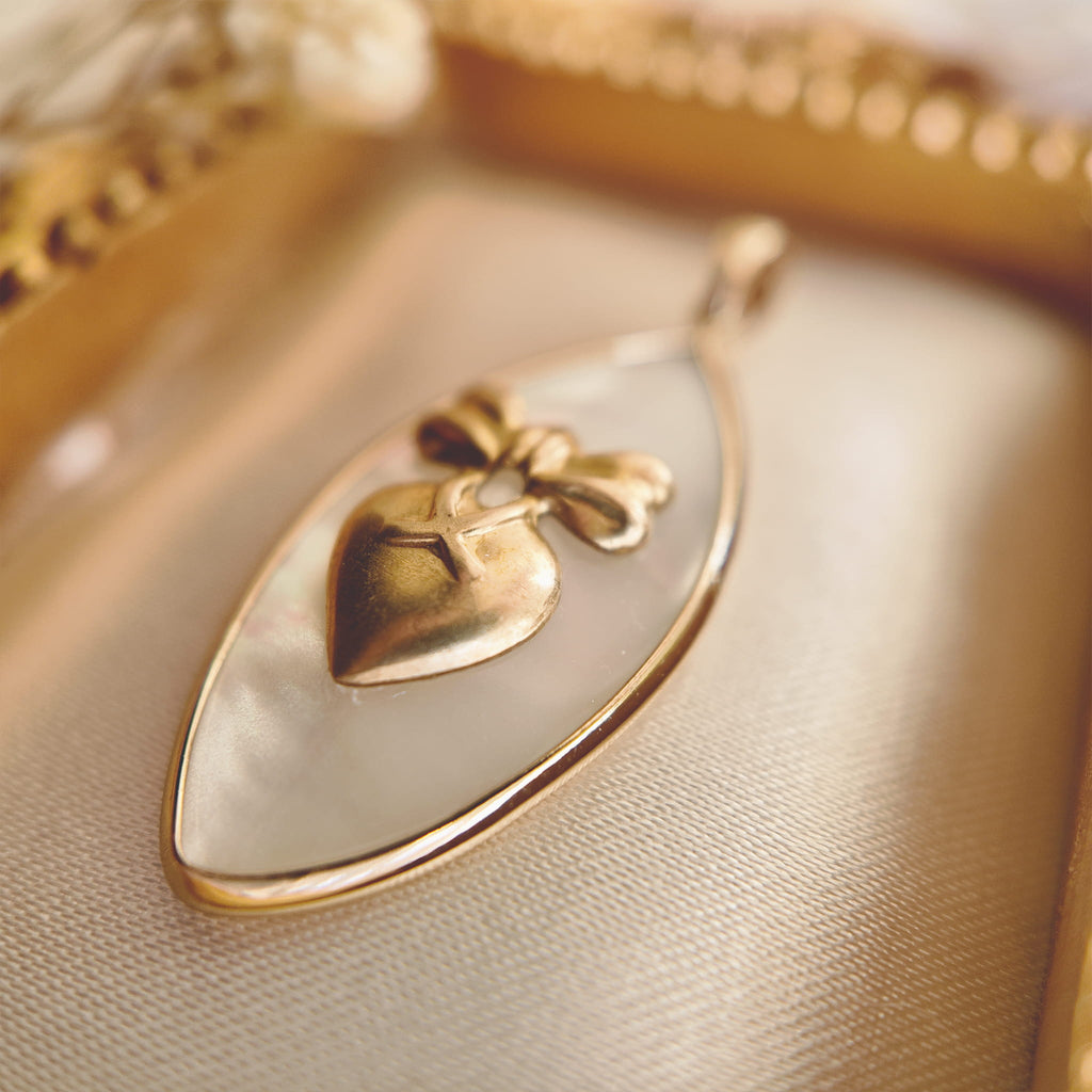 Texture detail of natural Mother-of-Pearl showing its stunning iridescent luster with shifting pink and green hues.