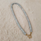 The "Arctic Serenade" necklace styled on a grey cashmere sweater to emphasize its "Icy Romance" and "Quiet Luxury" aesthetic, a piece of timeless, organic luxury.