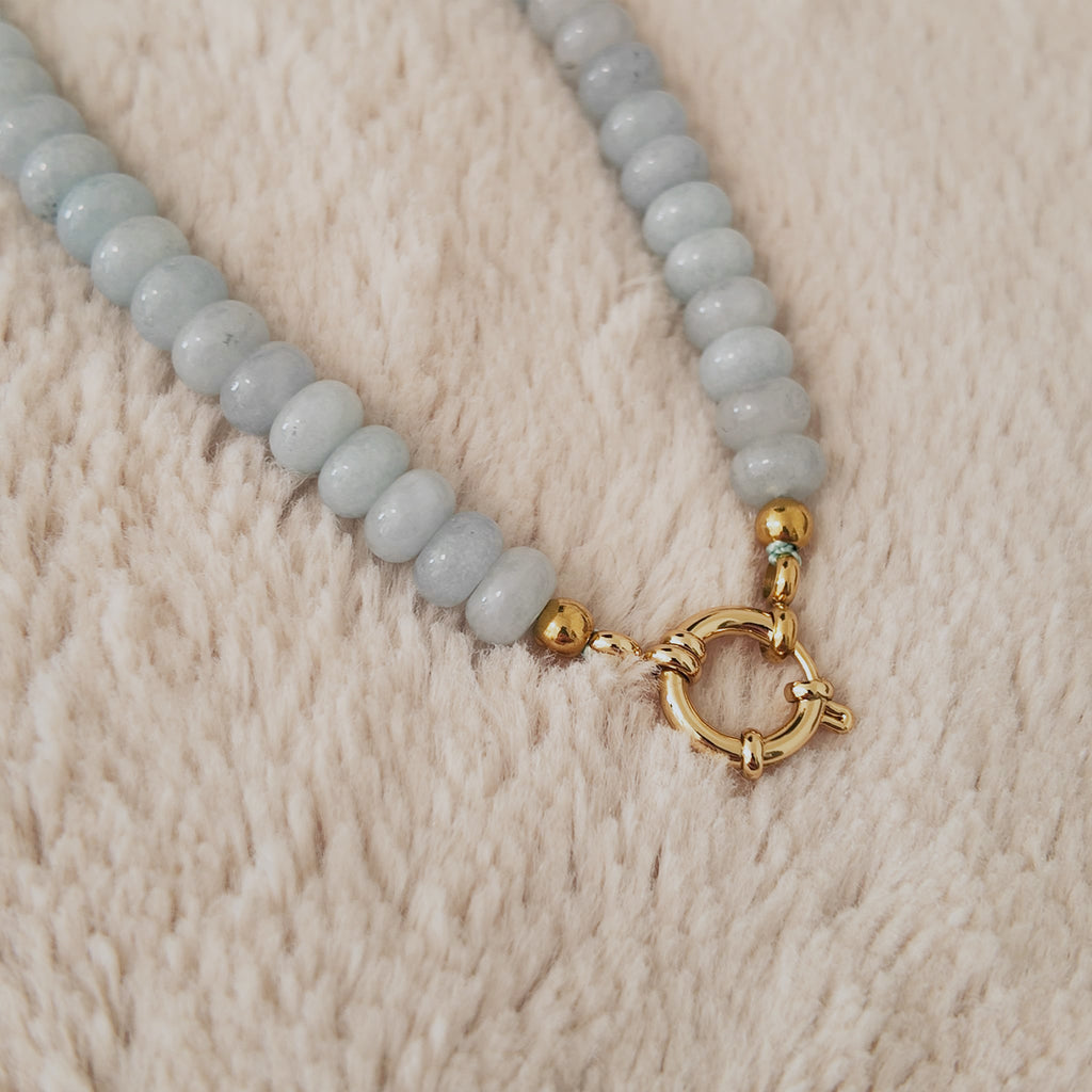 The "Arctic Serenade," a substantial, artisan-made beaded necklace, strung with organic, flat-round natural pale blue stone beads like Amazonite or Agate.