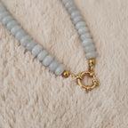 The "Arctic Serenade," a substantial, artisan-made beaded necklace, strung with organic, flat-round natural pale blue stone beads like Amazonite or Agate.