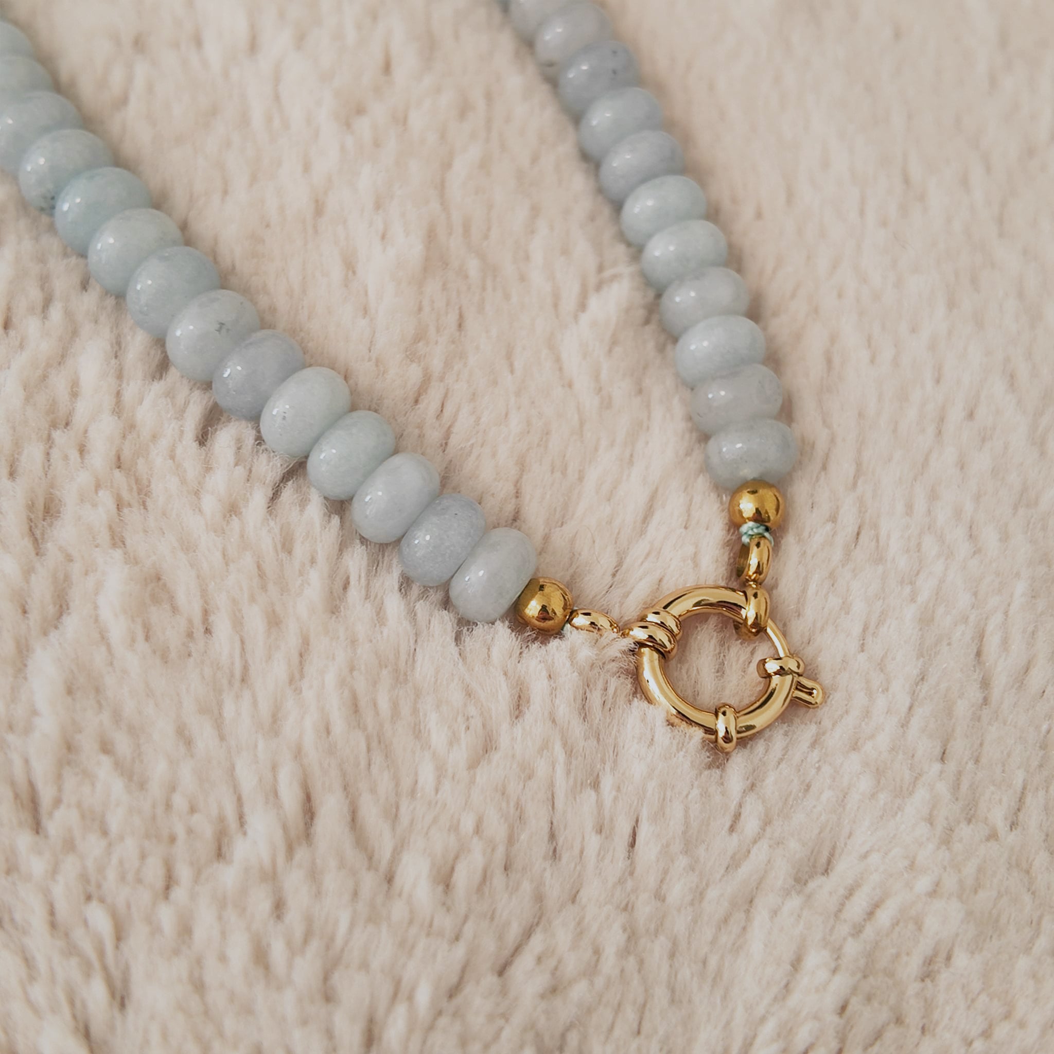 The "Arctic Serenade," a substantial, artisan-made beaded necklace, strung with organic, flat-round natural pale blue stone beads like Amazonite or Agate.