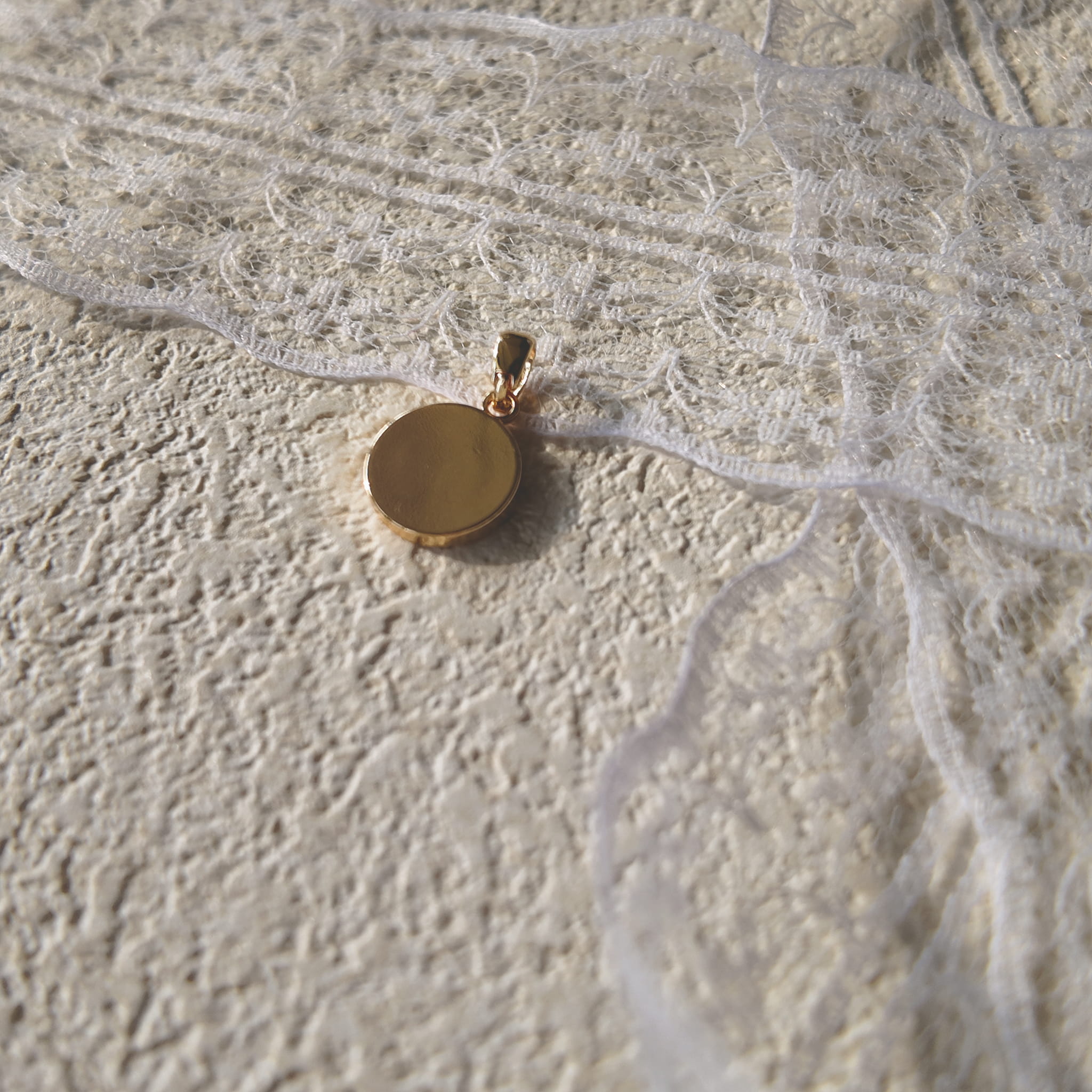 The reverse side of the "Ocean's Relic" pearl charm, showing the clean assembly and the natural, organic shape of the freshwater pearl.