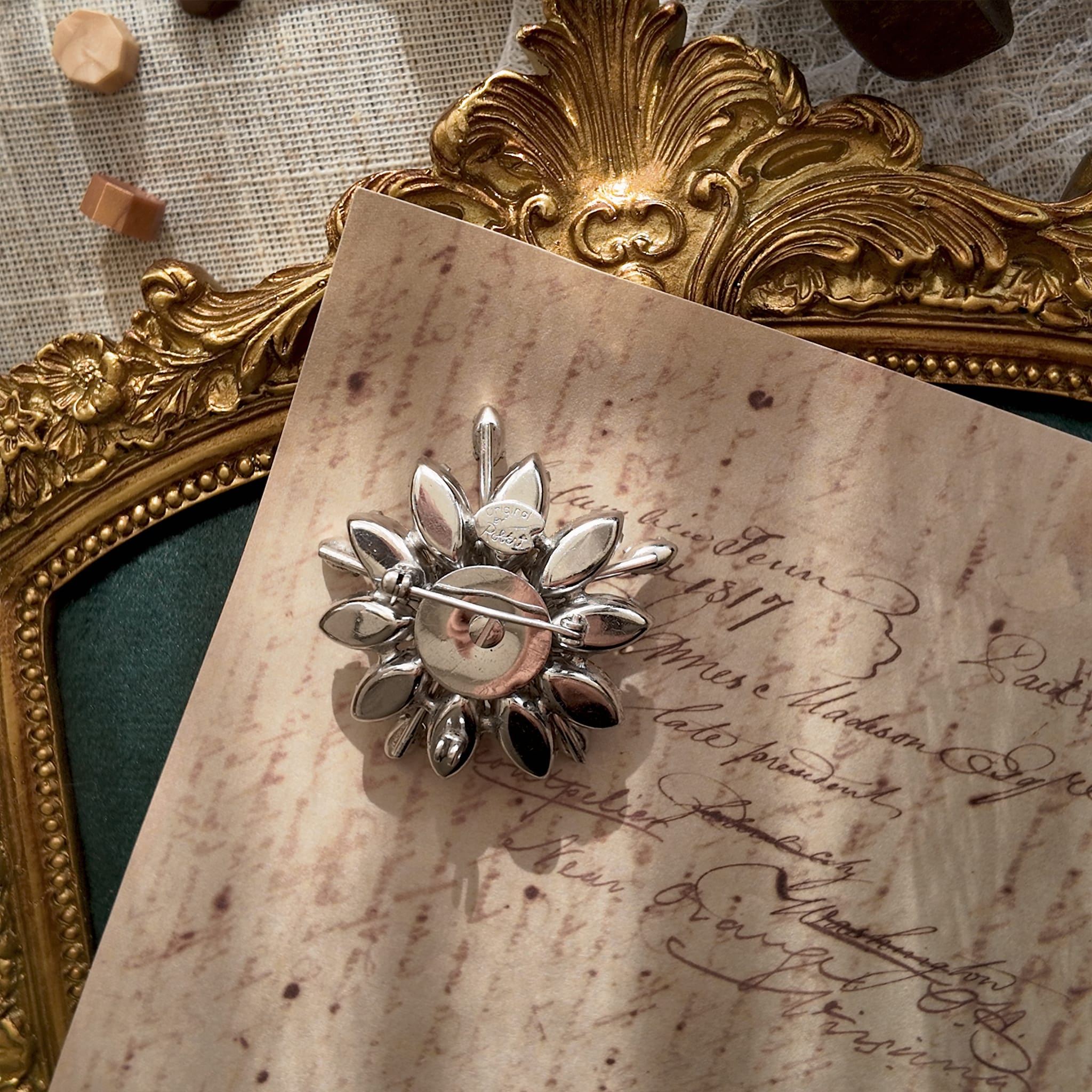 A close-up of the reverse side, showing the authentic artist's palette signature mark of "Original by Robert" and the built-in pendant hook.