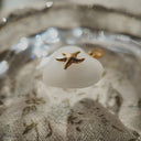 Side profile of the petite Milk Glass heart pendant, showing its form and the gold-plated bezel.