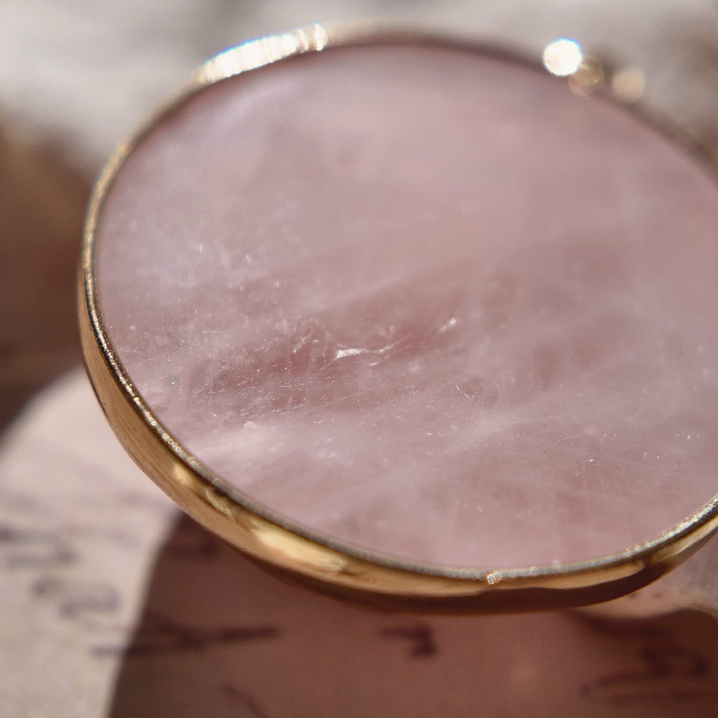 The reverse side of the upcycled Pink Aventurine charm, showcasing the clean bezel setting and the beautiful, natural patterns of the stone.