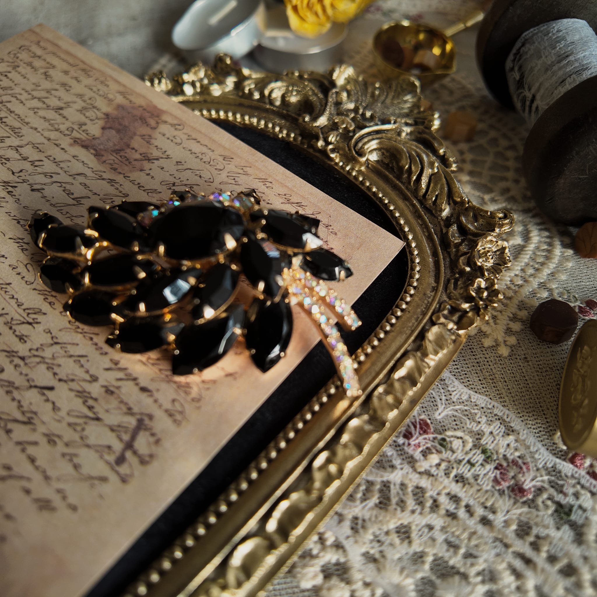 The Juliana "Prima Ballerina" brooch styled on a ballet program to emphasize its dramatic, graceful aesthetic, a perfect piece of Gothic Romance jewelry.