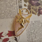 The ethereal fairy charm styled on a piece of white silk to emphasize its "Purity & Inner Light" aesthetic and its identity as a magical, spiritual gift.