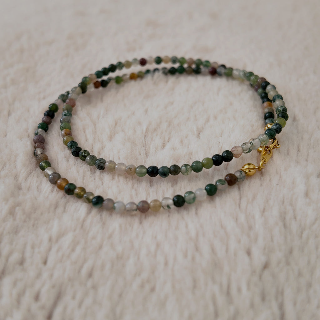 The reverse side of the handmade choker, showing the simple and secure gold-tone clasp and extender chain.