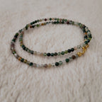 The reverse side of the handmade choker, showing the simple and secure gold-tone clasp and extender chain.