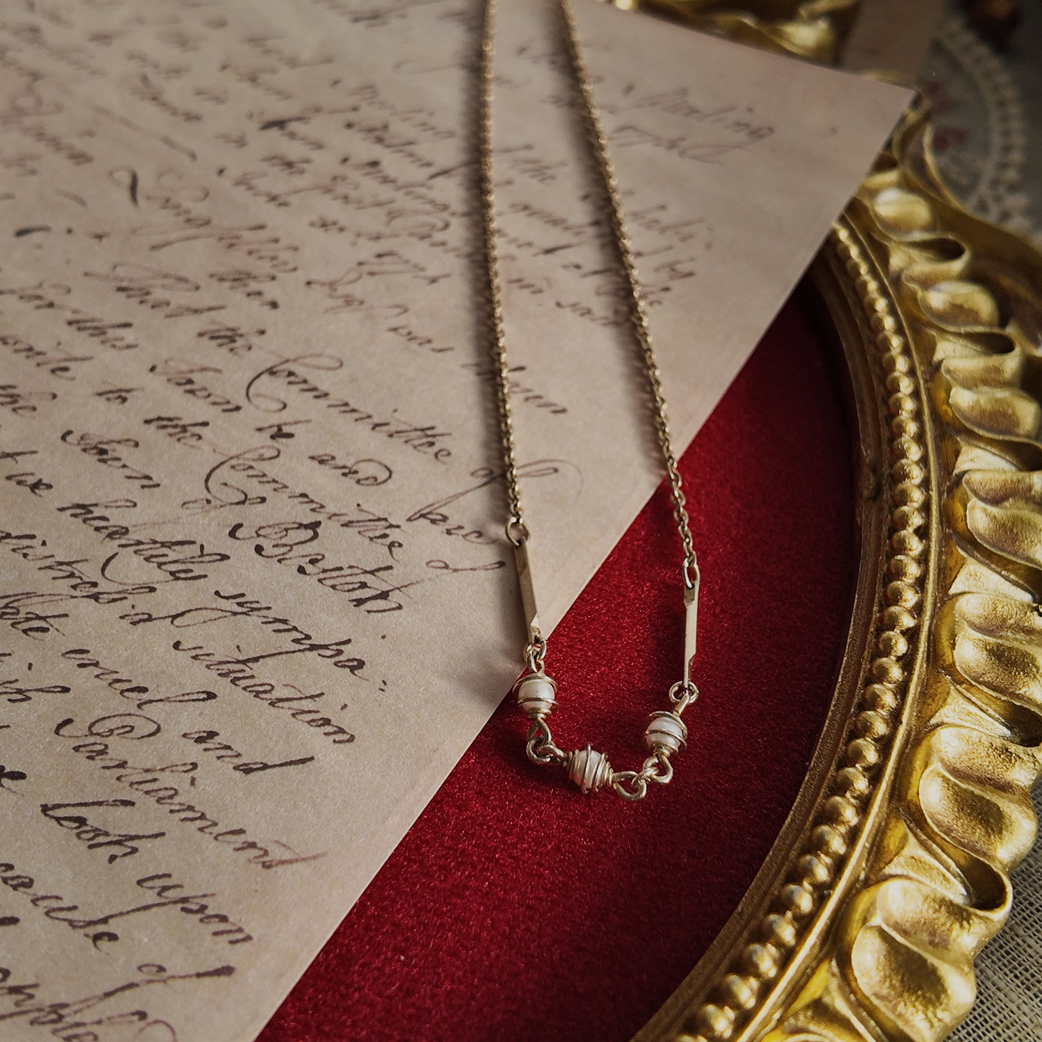 The "Quiet Rebel" Avon necklace styled on a philosophy book to emphasize its identity as a personal manifesto and a talisman for the free thinker.