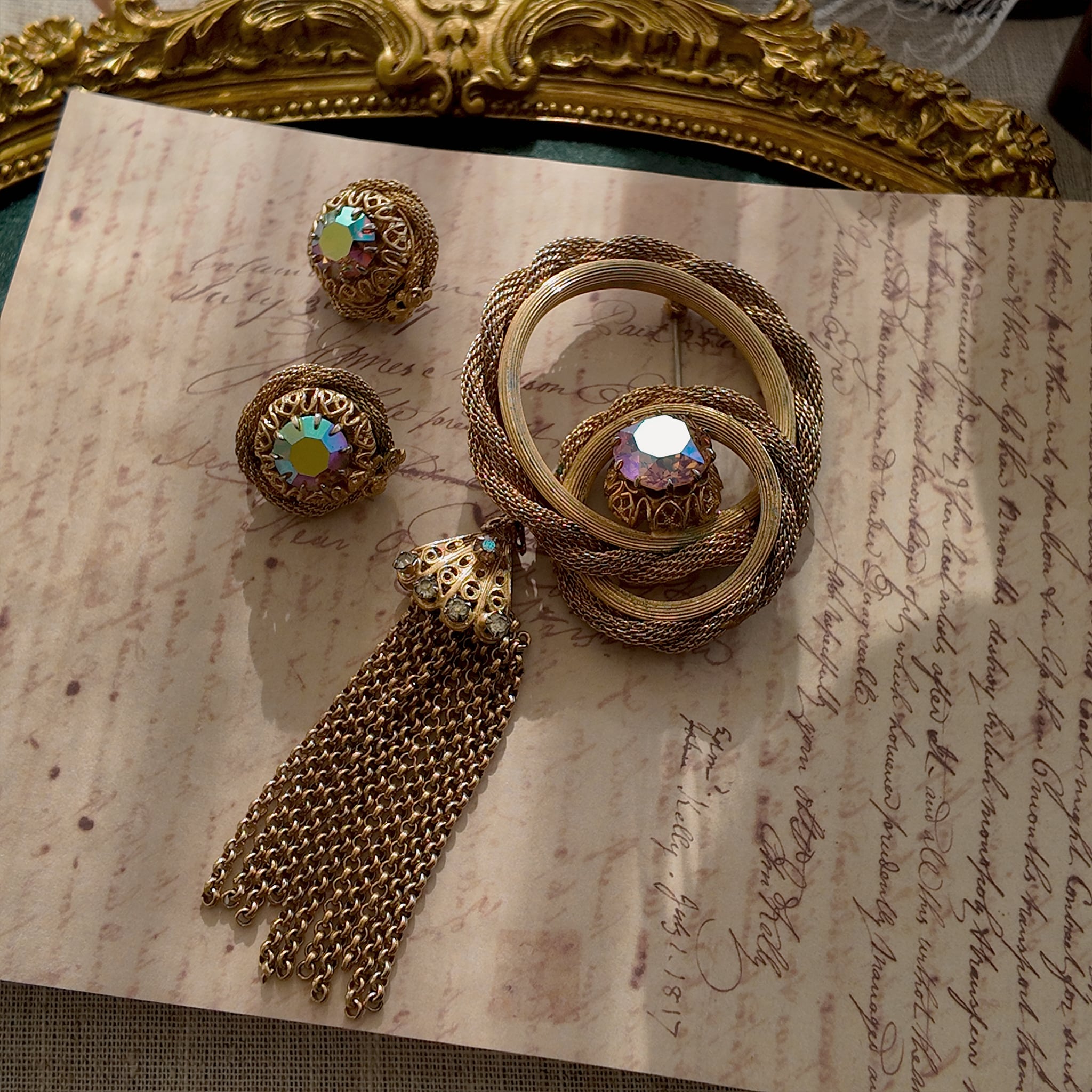 The "Echo of Opulence," an extremely rare vintage Vendôme demi-parure by Coro, featuring a woven gold tassel brooch and matching earrings with AB crystals.