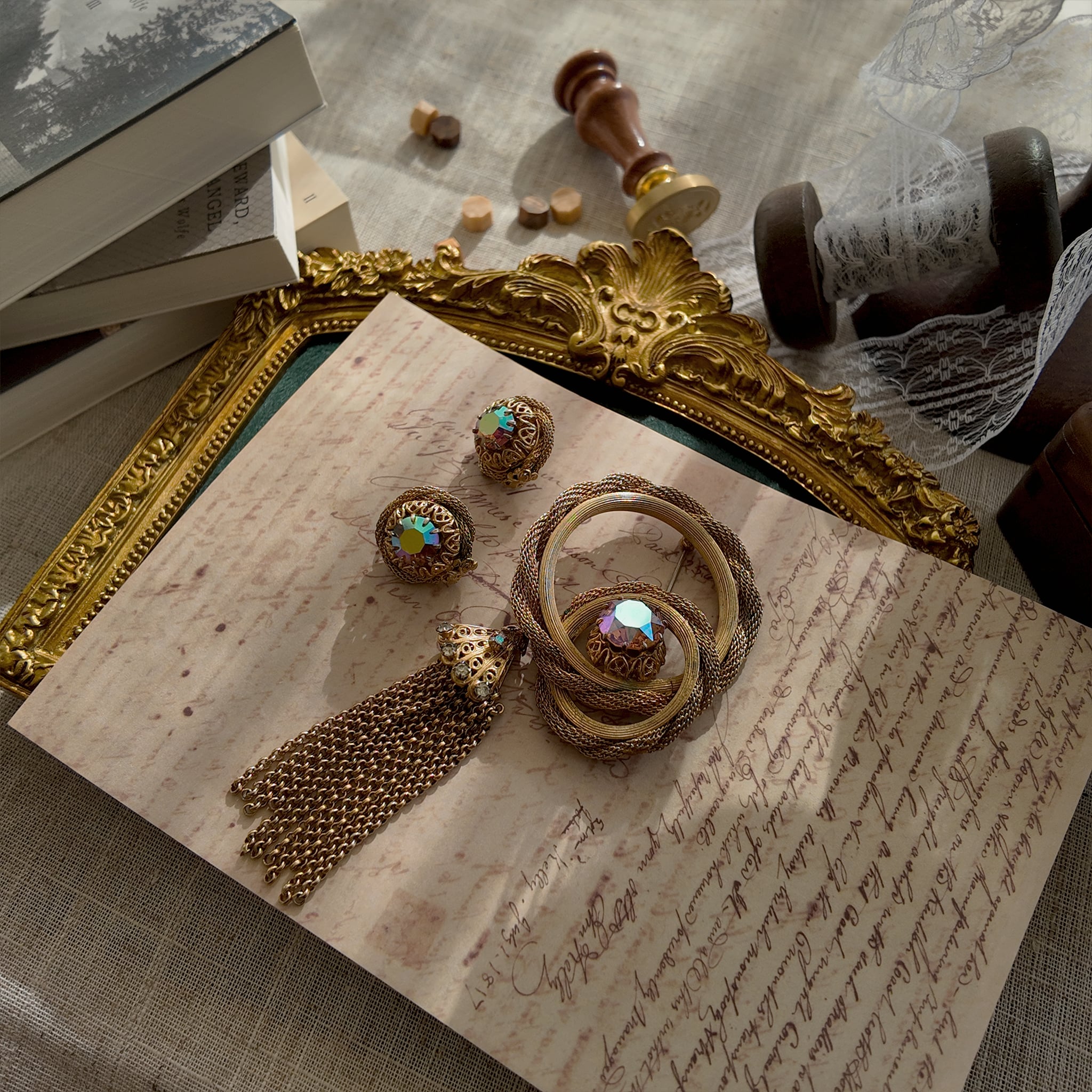 The "Echo of Opulence," an extremely rare vintage Vendôme demi-parure by Coro, featuring a woven gold tassel brooch and matching earrings with AB crystals.