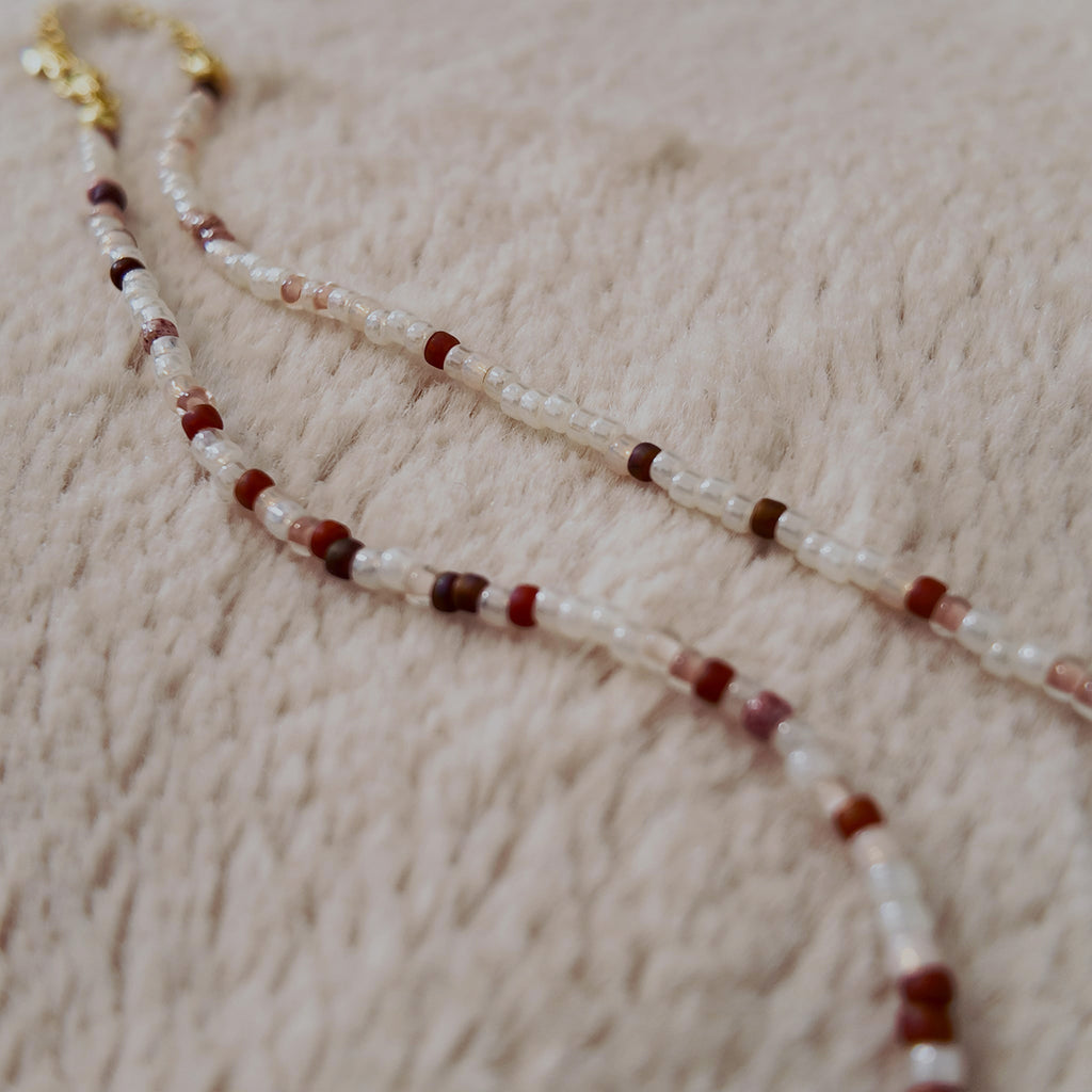 The "Sacred Healer" choker styled with a white rose and a drop of red to emphasize its "Sacred Romance" and "Clinical Chic" aesthetic, a talisman of redemption.