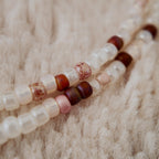 The "Sacred Healer" choker styled with a white rose and a drop of red to emphasize its "Sacred Romance" and "Clinical Chic" aesthetic, a talisman of redemption.