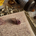 The small, rustic 1928 Jewelry floral earrings worn on the ear, showcasing their demure, unassuming charm perfect for a natural, Cottagecore aesthetic.