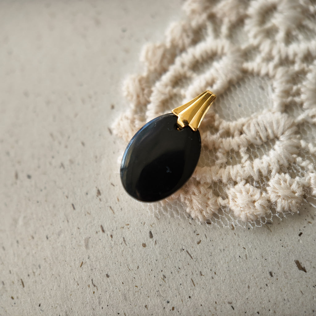 The reverse side of the "Shadow Butterfly" pendant, showcasing the clean gold-plated bail and the quality of the handcrafted assembly on this reimagined vintage piece.