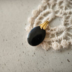 The reverse side of the "Shadow Butterfly" pendant, showcasing the clean gold-plated bail and the quality of the handcrafted assembly on this reimagined vintage piece.