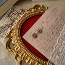 The reverse side, showing the authentic "ART ©" signature, as well as the significant wear and plate loss on the original earring backs.