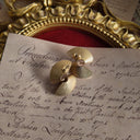 The reverse side, showing the authentic "AVON" signature on the back of the heavily worn, yet charmingly imperfect vintage gold earrings.