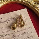 A close-up of the reverse side, showing the authentic "AVON" signature, as well as visible fading and oxidation on the gold-tone plating.
