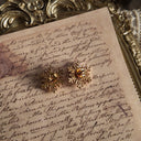 The reverse side of the earrings, showing the authentic "AVON" signature on the original clutches, confirming their excellent, collector-grade condition.
