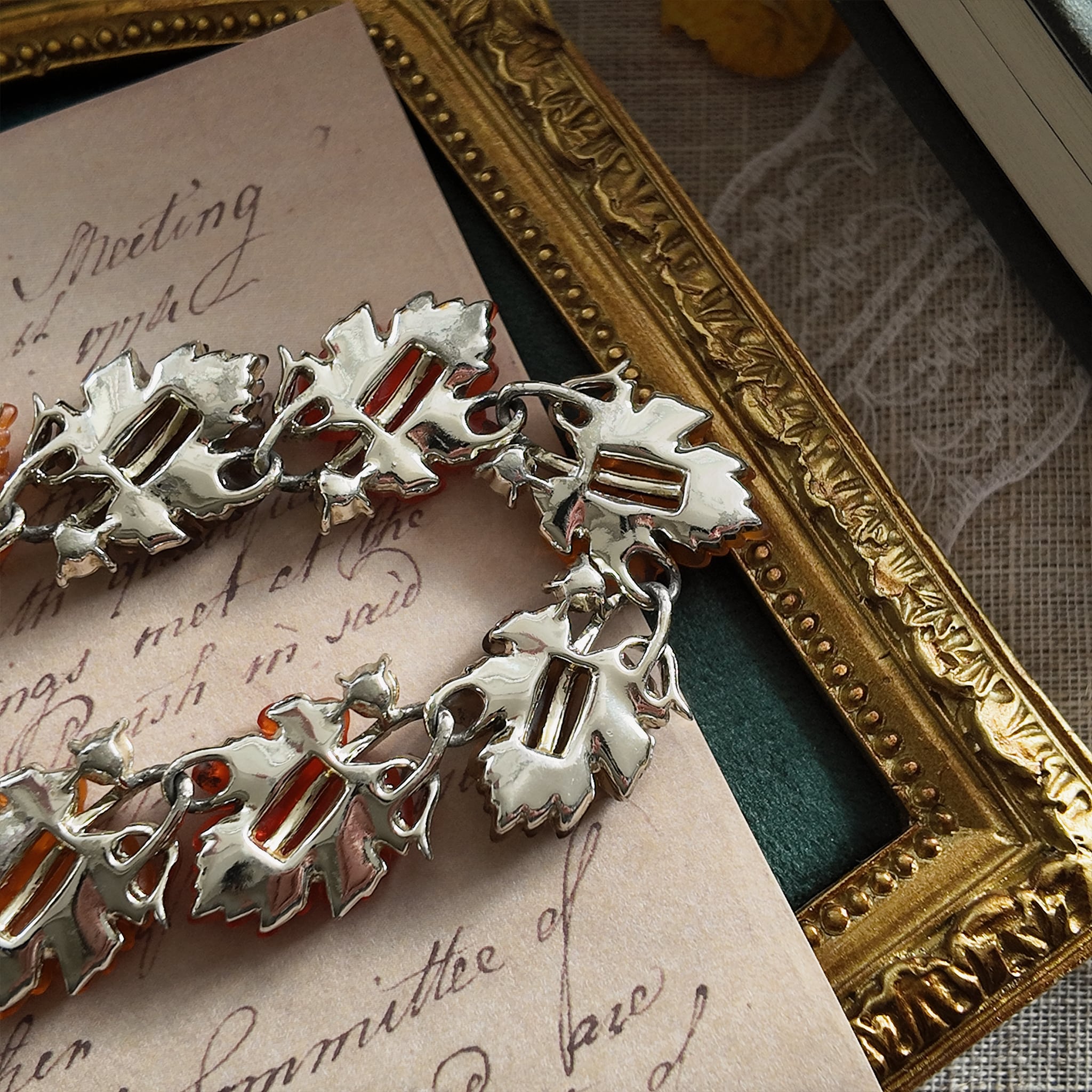 A detailed photo honestly showing the heavy aging and visible rust on the extender chain of the Lisner necklace, which is sold as-is at a reduced price.