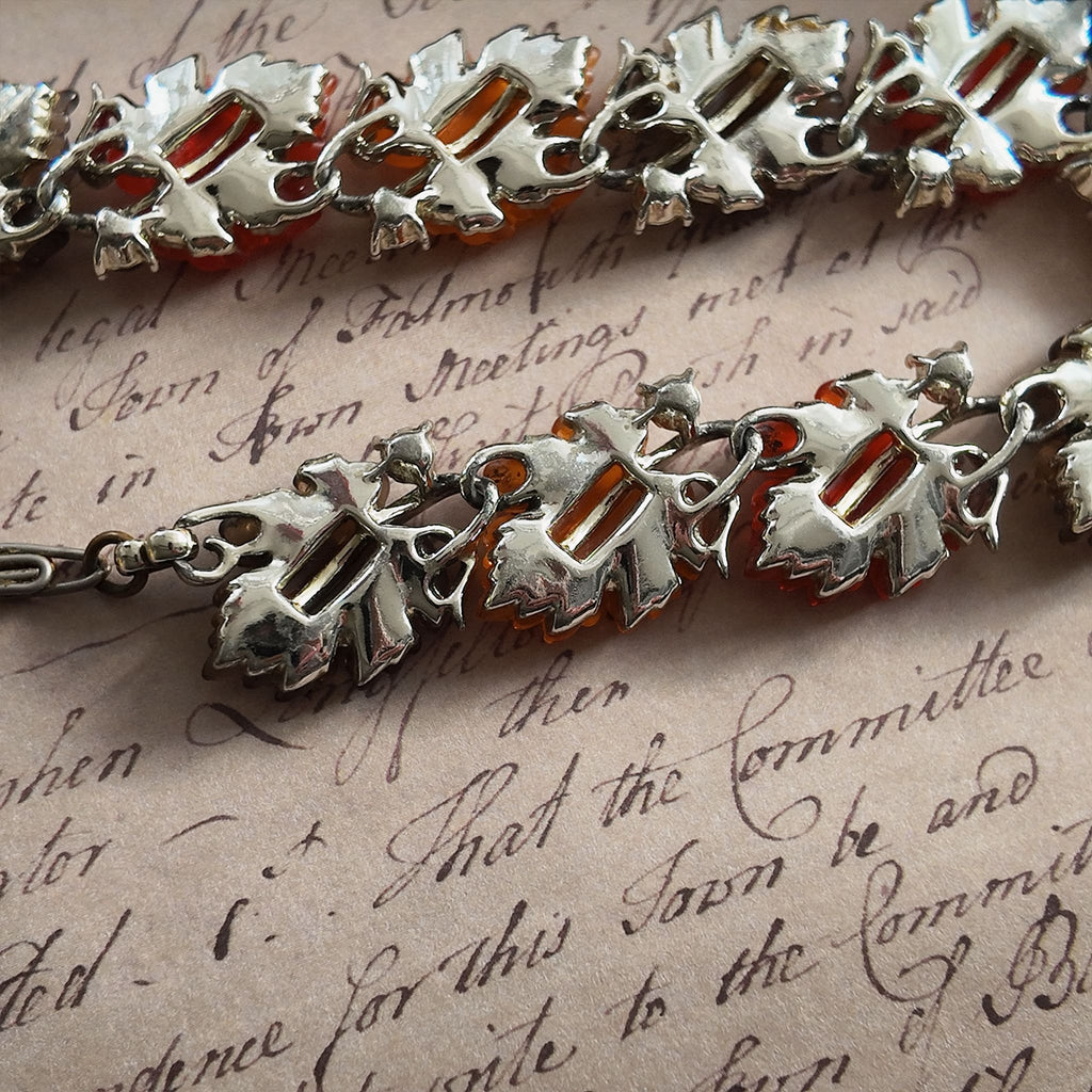 A detailed photo honestly showing the heavy aging and visible rust on the extender chain of the Lisner necklace, which is sold as-is at a reduced price.