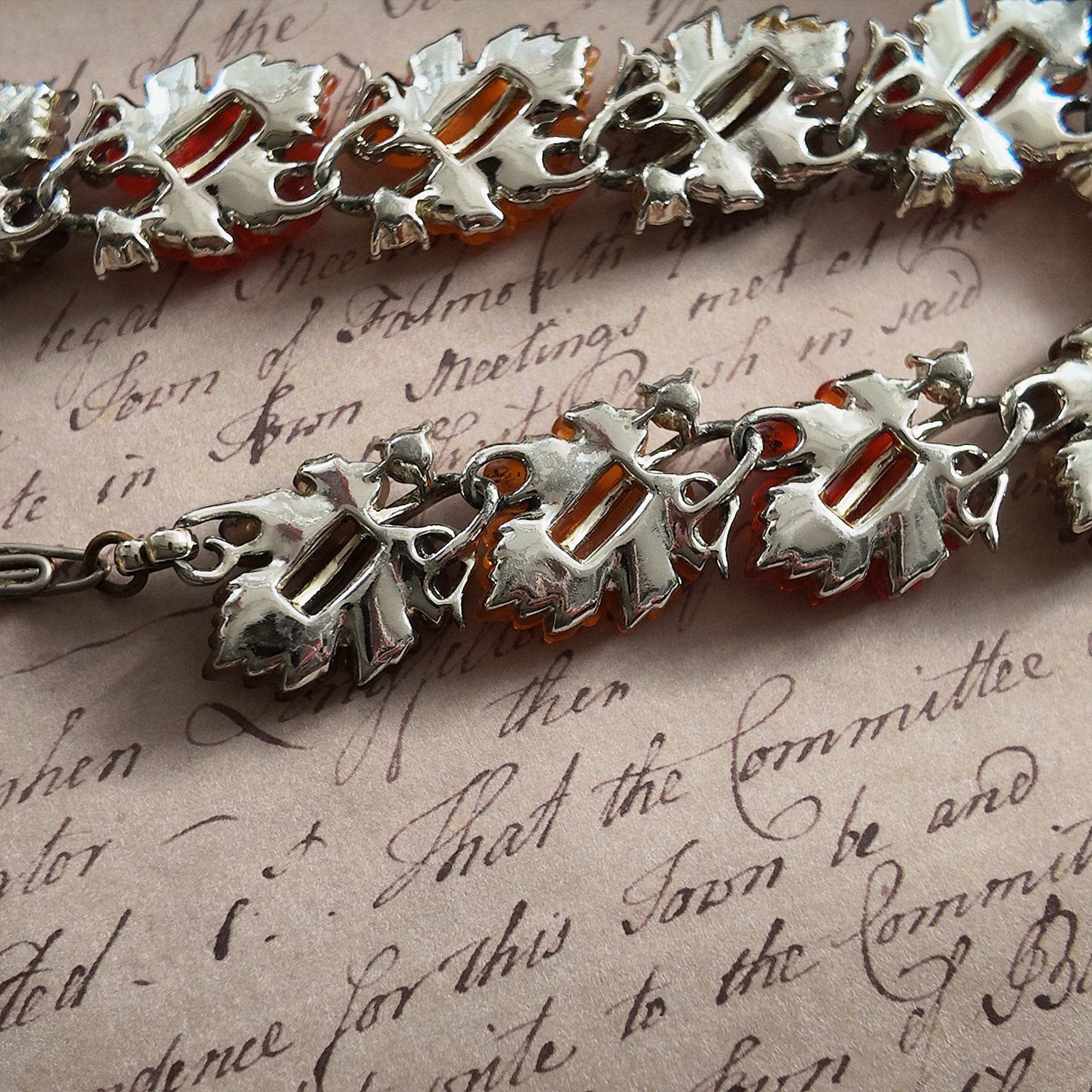 A detailed photo honestly showing the heavy aging and visible rust on the extender chain of the Lisner necklace, which is sold as-is at a reduced price.