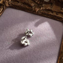 A close-up of the reverse side, showing the authentic "SAQ" signature on the clutch of the near-mint condition vintage earrings.