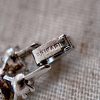 A close-up of the authentic "TRIFARI" signature on the clasp, also honestly showing the minor surface wear on the back of the vintage bracelet.
