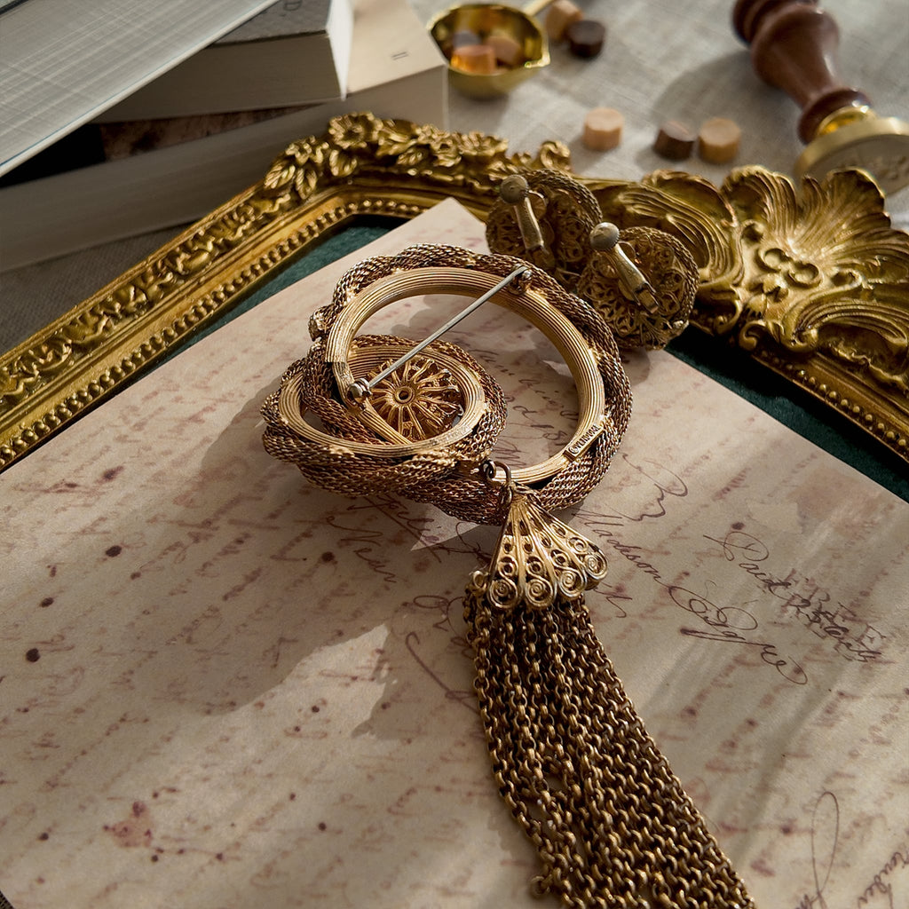 The reverse side of the brooch, showing the authentic "Vendôme" signature, as well as noticeable imperfections and wear at a connection point.