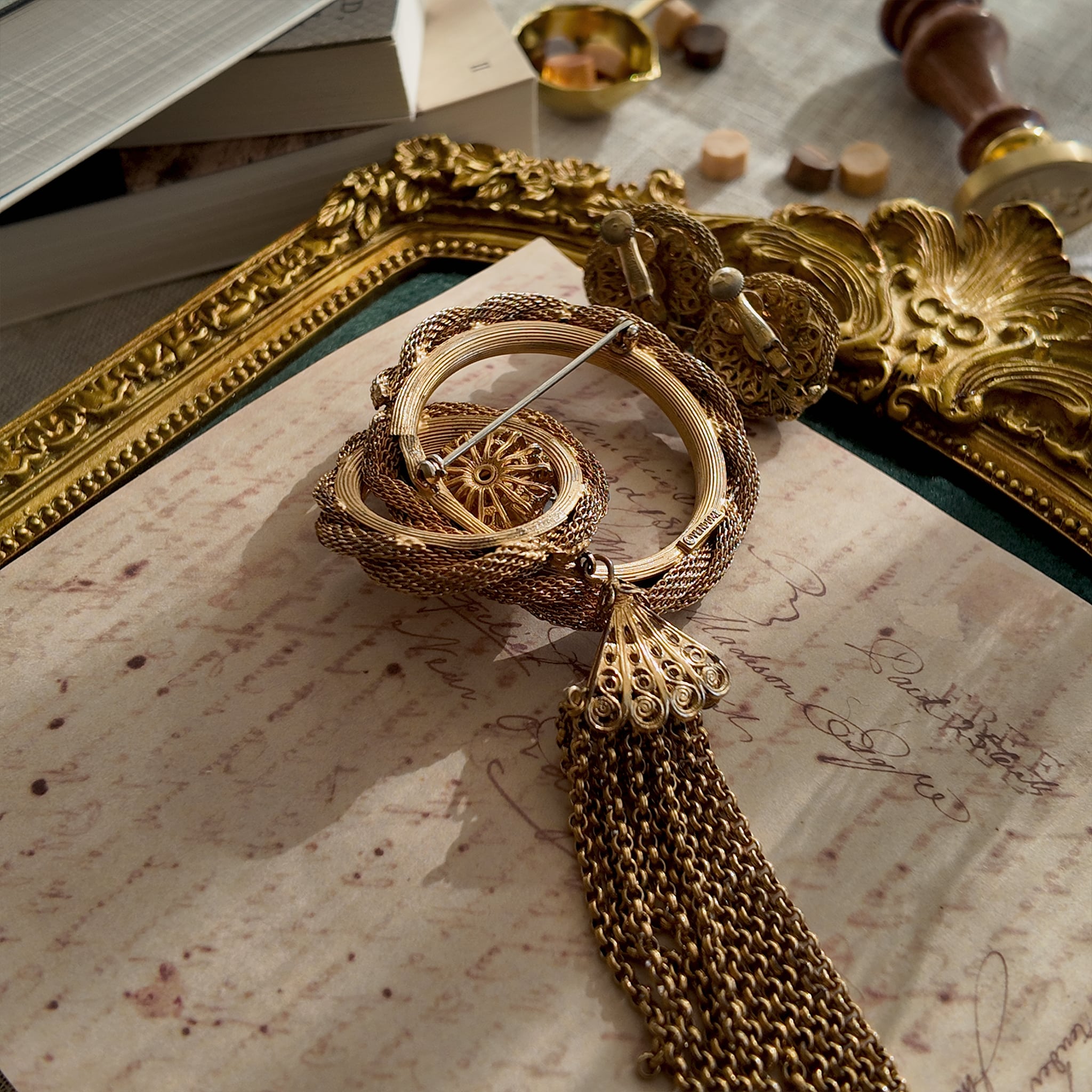 The reverse side of the brooch, showing the authentic "Vendôme" signature, as well as noticeable imperfections and wear at a connection point.