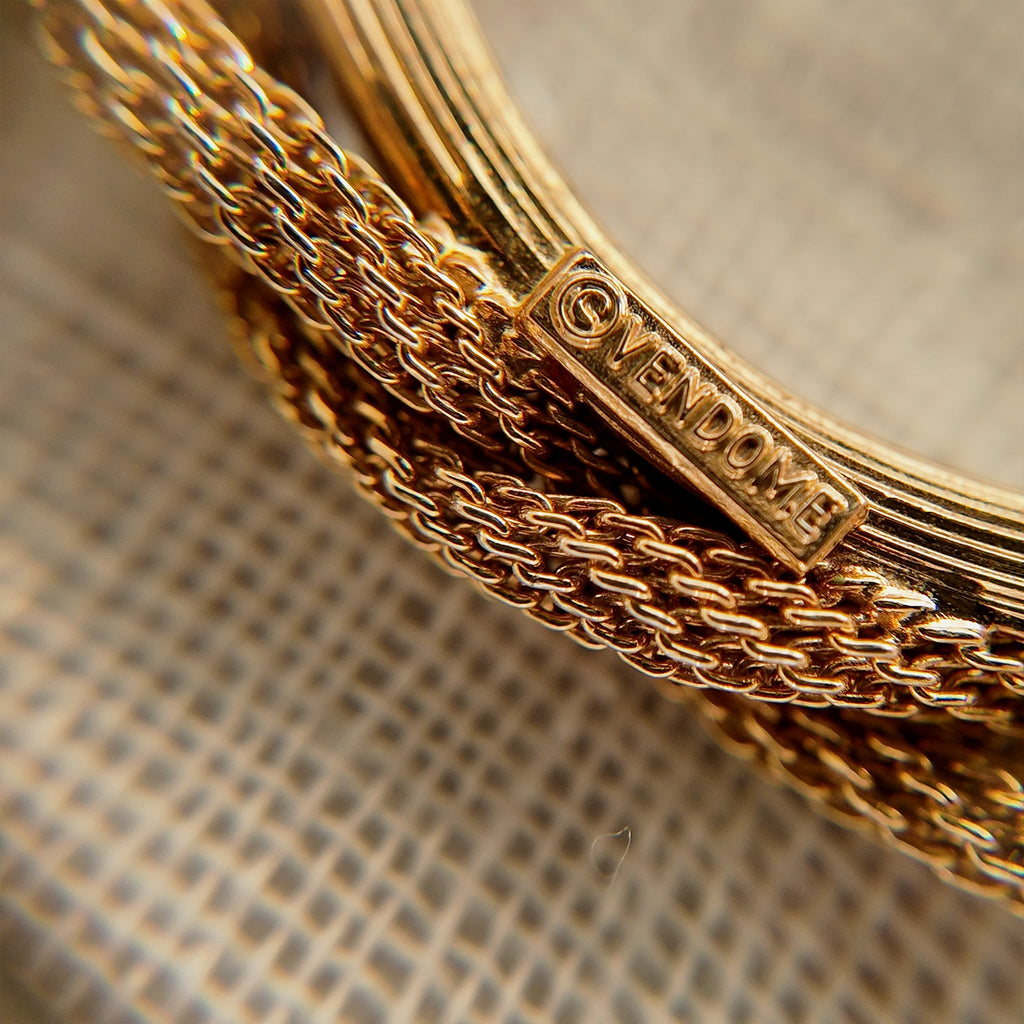 The reverse side of the brooch, showing the authentic "Vendôme" signature, as well as noticeable imperfections and wear at a connection point.