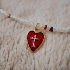 The "Sacred Healer," a Soft Goth style beaded choker necklace, featuring mixed texture white and red seed beads and a central red alloy metal Heart-Cross pendant.