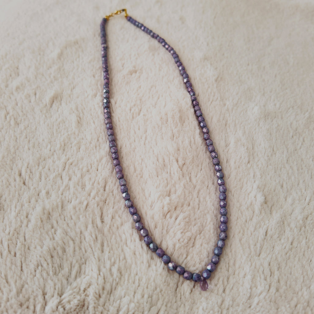 The "Twilight Tear" necklace styled with dried lavender to emphasize its "Twilight Hues" and its identity as a piece of soft, Witchy, ethereal jewelry.