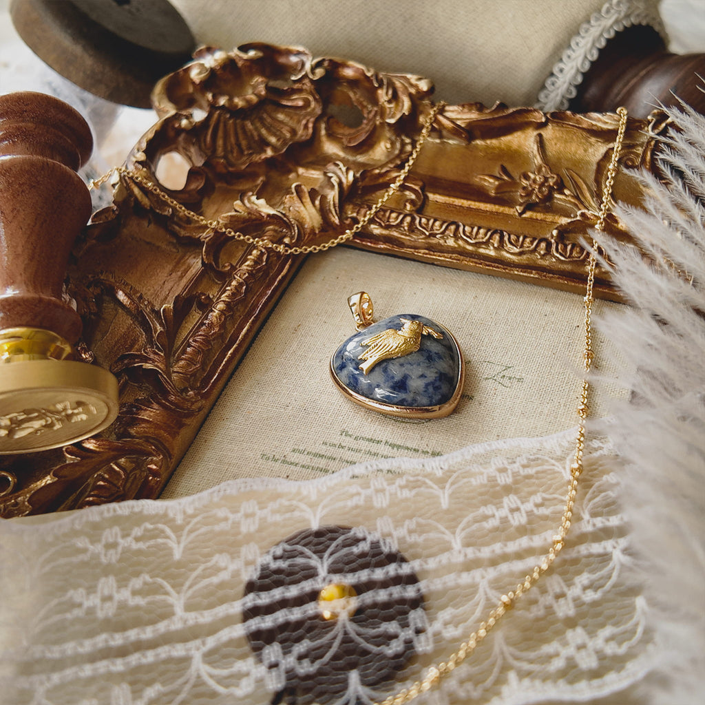 Side view of the pendant showing the solid feel of the stone and the gold-plated bezel construction.