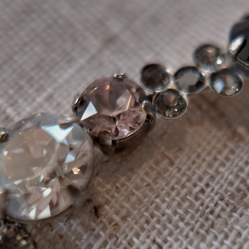 A detailed photo honestly showing the one tiny missing clear rhinestone on the Sorrelli bracelet, which is sold as-is at a reduced price.