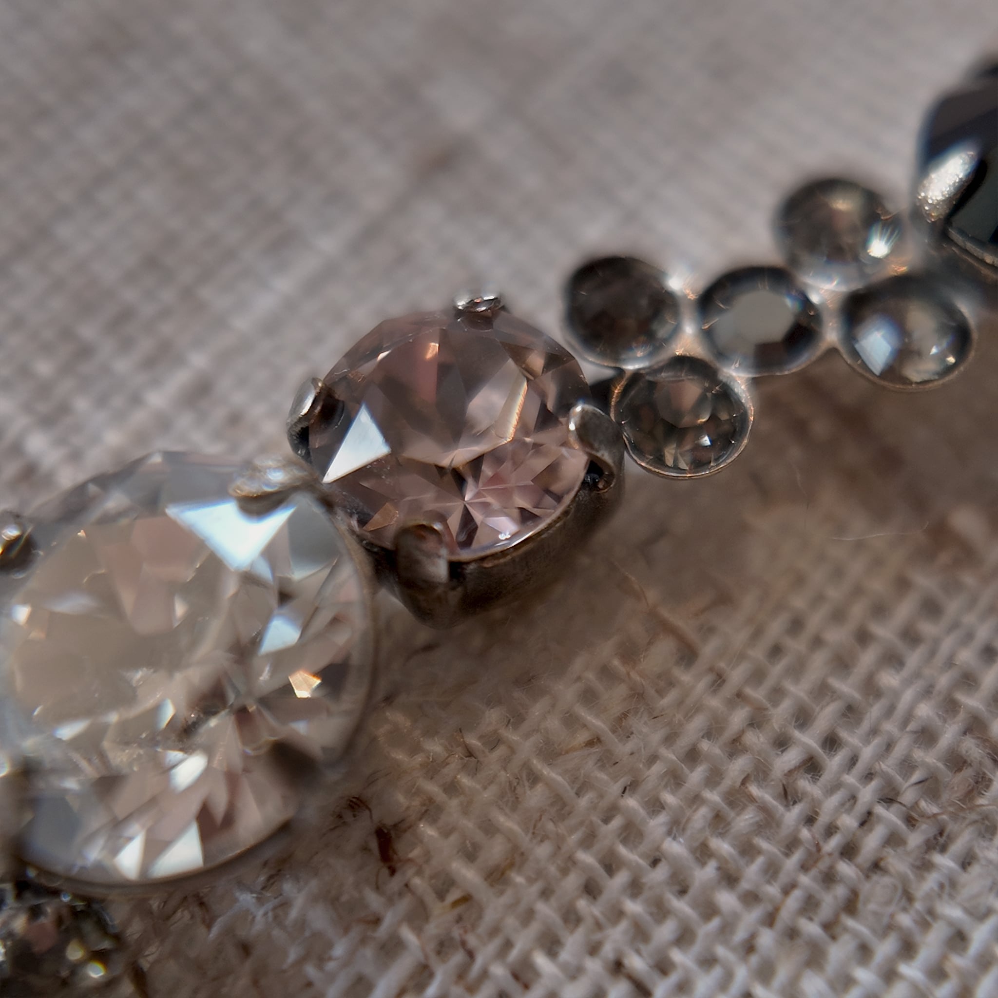 A detailed photo honestly showing the one tiny missing clear rhinestone on the Sorrelli bracelet, which is sold as-is at a reduced price.