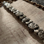 A close-up of the authentic "Sorrelli" signature hang tag on the back of the antiqued silver-tone vintage statement bracelet.