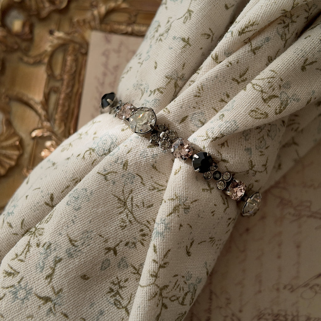 The "Rebel Poetess," a vintage Sorrelli bracelet featuring a charming mix of pink, black, and clear crystals in an antiqued silver-tone setting.