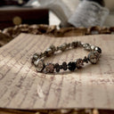The "Rebel Poetess," a vintage Sorrelli bracelet featuring a charming mix of pink, black, and clear crystals in an antiqued silver-tone setting.