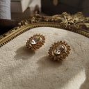 The Trifari crystal cluster earrings worn on the ear, showcasing their incredible, diamond-like sparkle and their identity as the perfect cocktail party accessory.