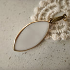 The reverse side of the fairycore-inspired "Ticket to Dreamland" pendant, showcasing the clean bezel setting and the quality of the handcrafted assembly.