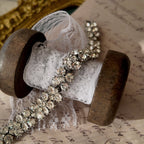 An angled view of the three-row rhinestone bracelet, highlighting the fluid movement of the silver-tone links and the exceptional fire of the crystals.